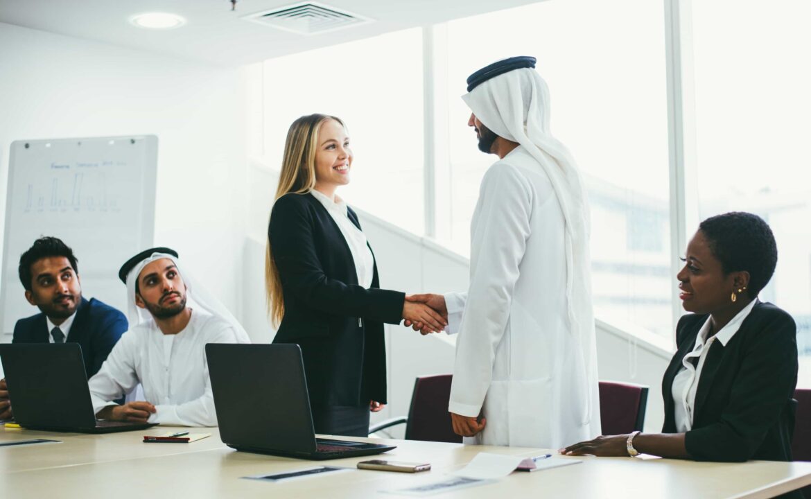 Mixed business team in Dubai. Business meeting with men wearing